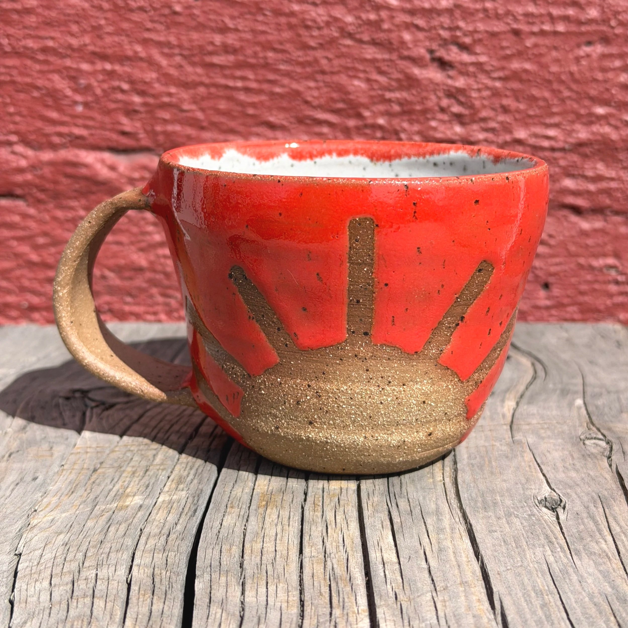 Bright colored sunshine mug in brown speckled clay