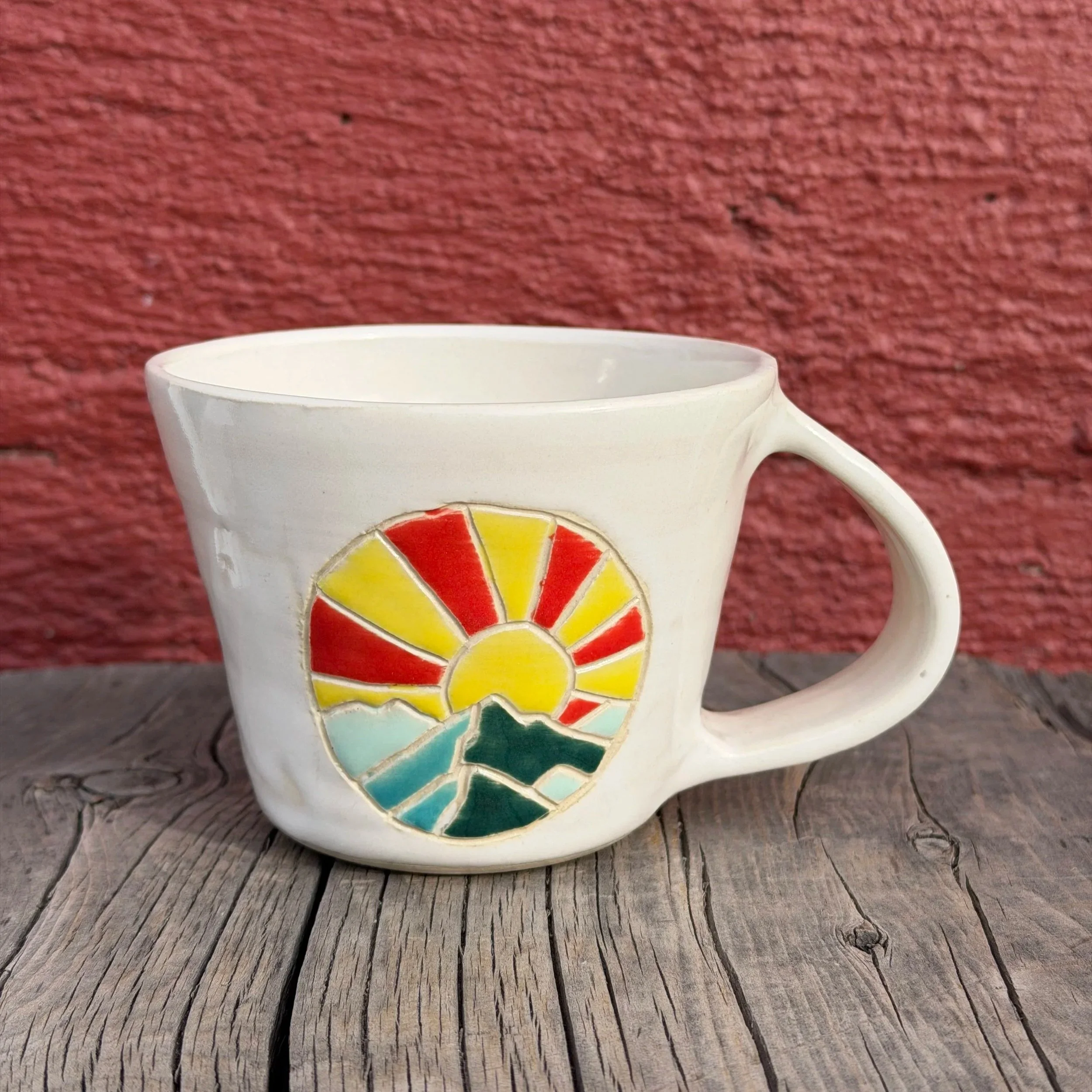 Handmade wheel thrown multi colored sunset and mountains on white clay mug modern design stoneware