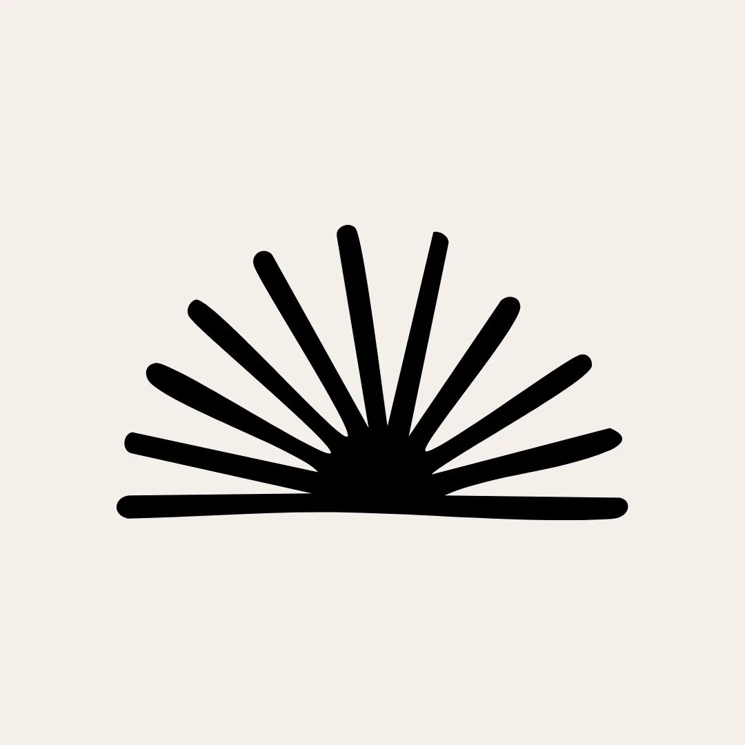 Black abstract sunburst design on a beige background.