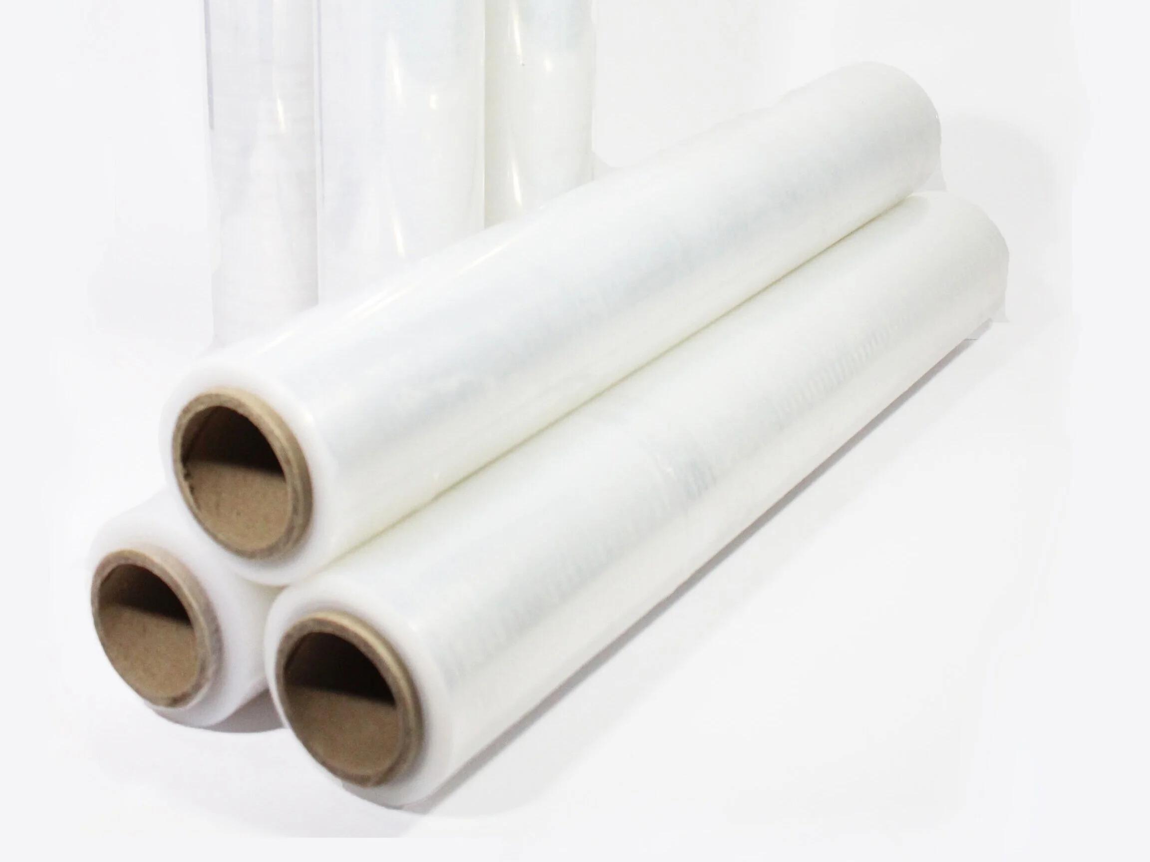 Three rolls of stretch plastic wrap stacked on top of each other, with additional rolls in the background.