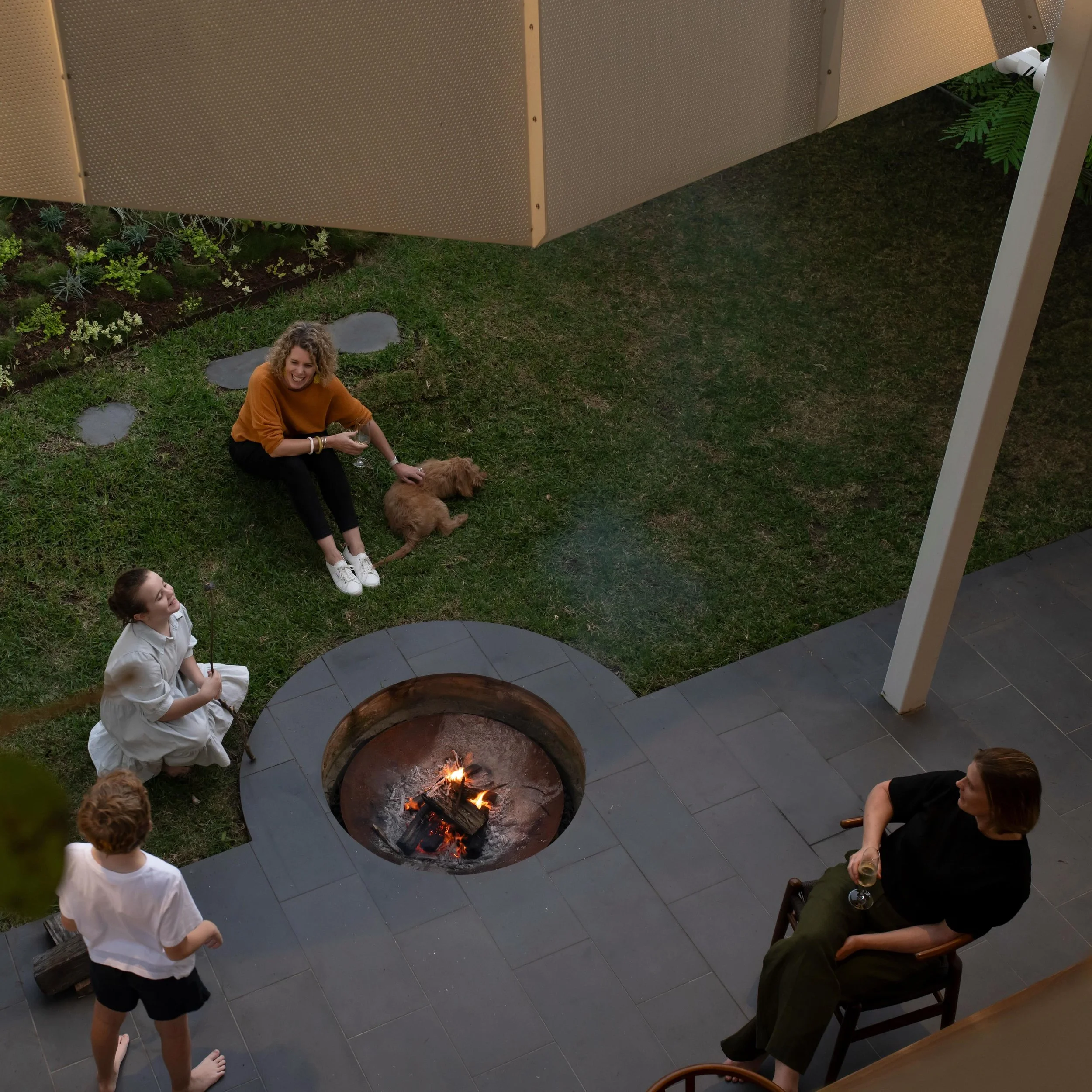 Folding one material.

Our Cornerstone project plays with folding perforated metal into different functions &amp; experiences.
Wrapping an outdoor room, perfect for shaded entertainment. One fold marks the transition in seasons where the integrated f