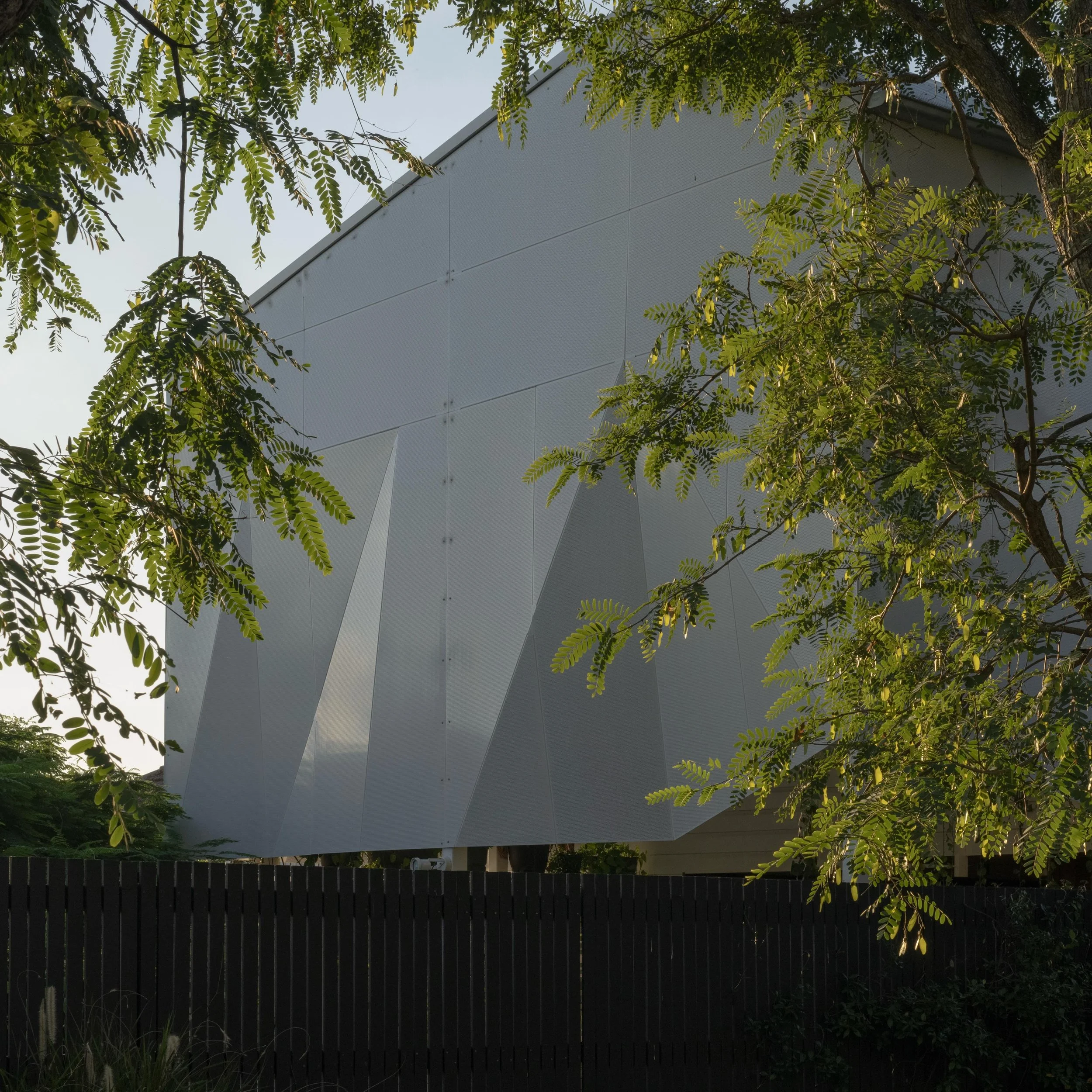Folding one material.

Our Cornerstone project plays with folding perforated metal into different functions &amp; experiences.
From the outside it&rsquo;s performing as a curtain wrapping a double height external space. 
It appears solid from here ye