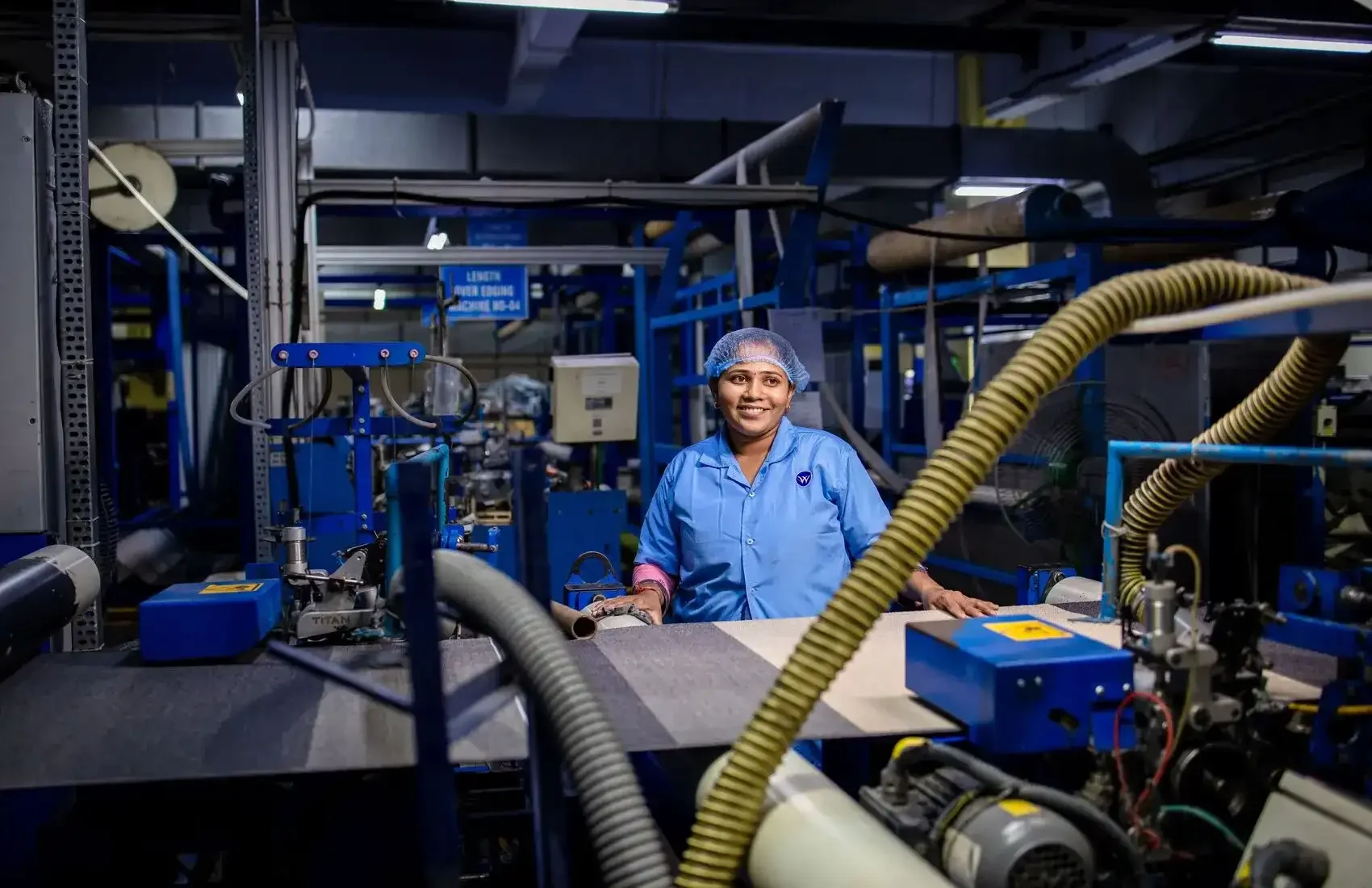 Industrial manufacturing assembly line with heavy machinery illustrating operating efficiency, production costs and competitiveness.