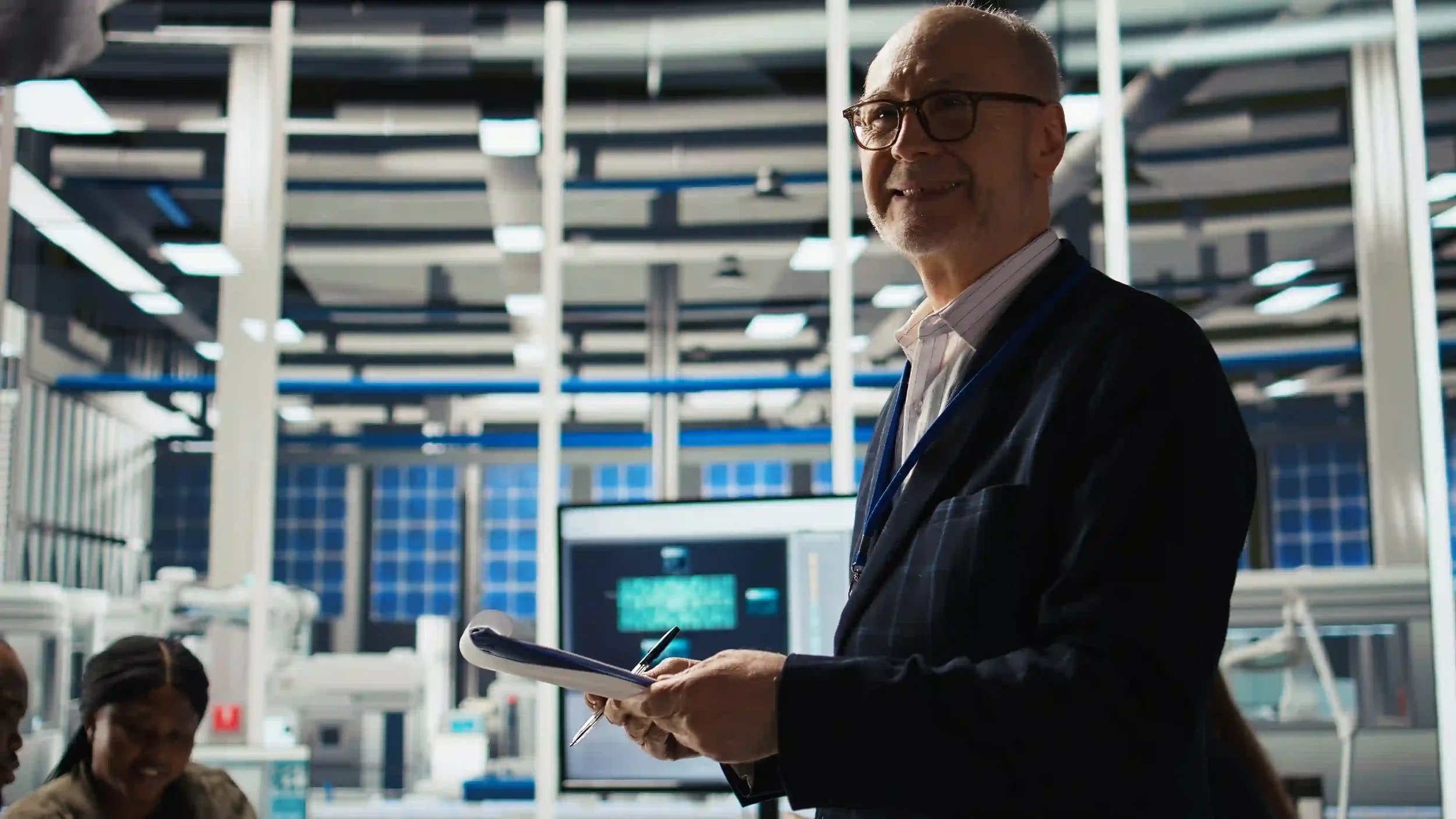 Senior industrial executive overlooking an advanced manufacturing production environment