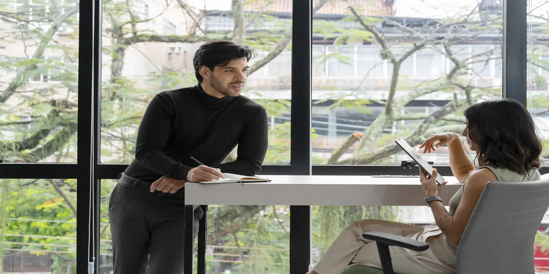 Two executives in a refined meeting room having a serious and calm confidential business discussion