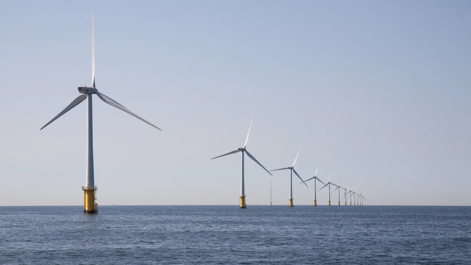 Aerial view of a large offshore wind farm at sunrise, illustrating renewable energy infrastructure and regional clean energy investment across Asia-Pacific.