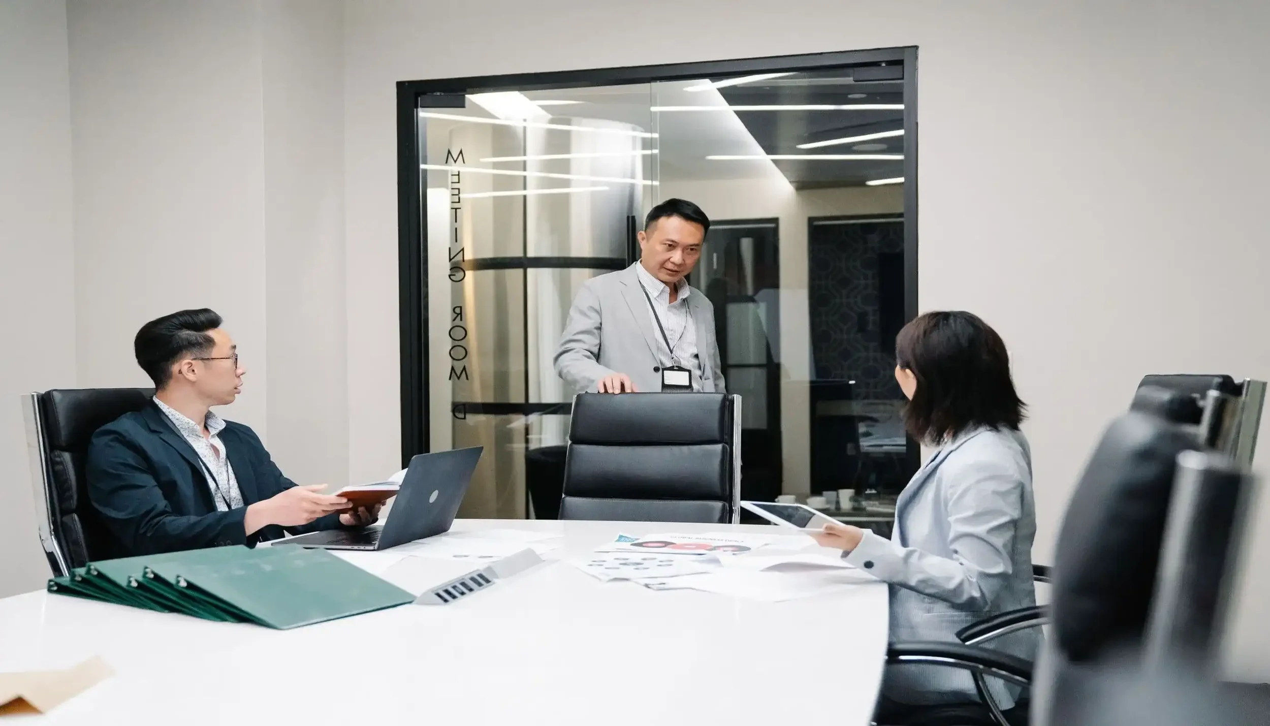 Executive leadership team reviewing strategic transformation and business consulting case studies in Asia