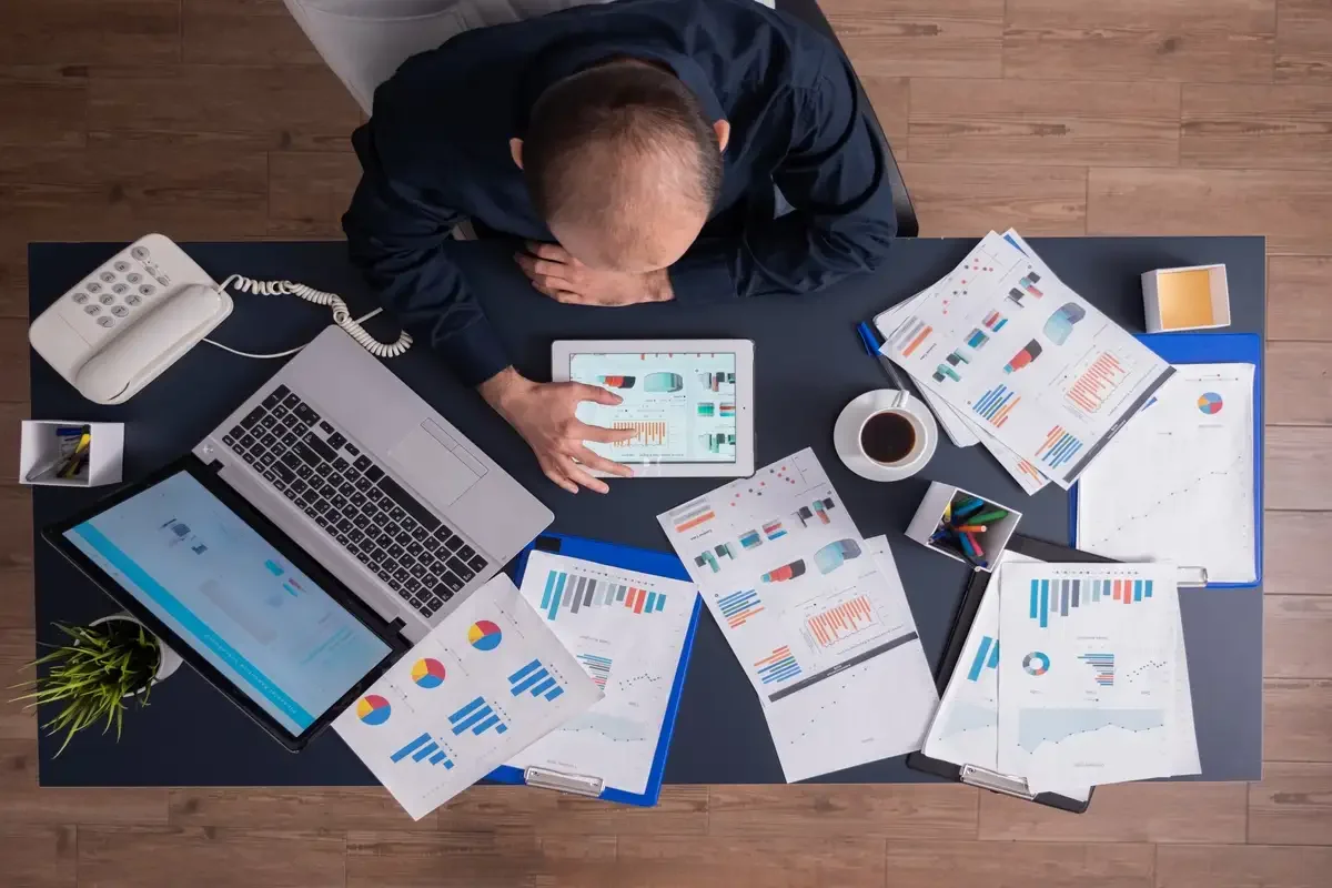 Executive overwhelmed by multiple dashboards, reports, analytics, and business performance metrics.