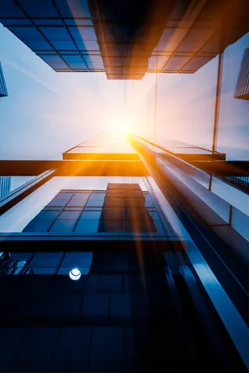 Upward view of modern skyscrapers illustrating strategic market entry development and  transformation