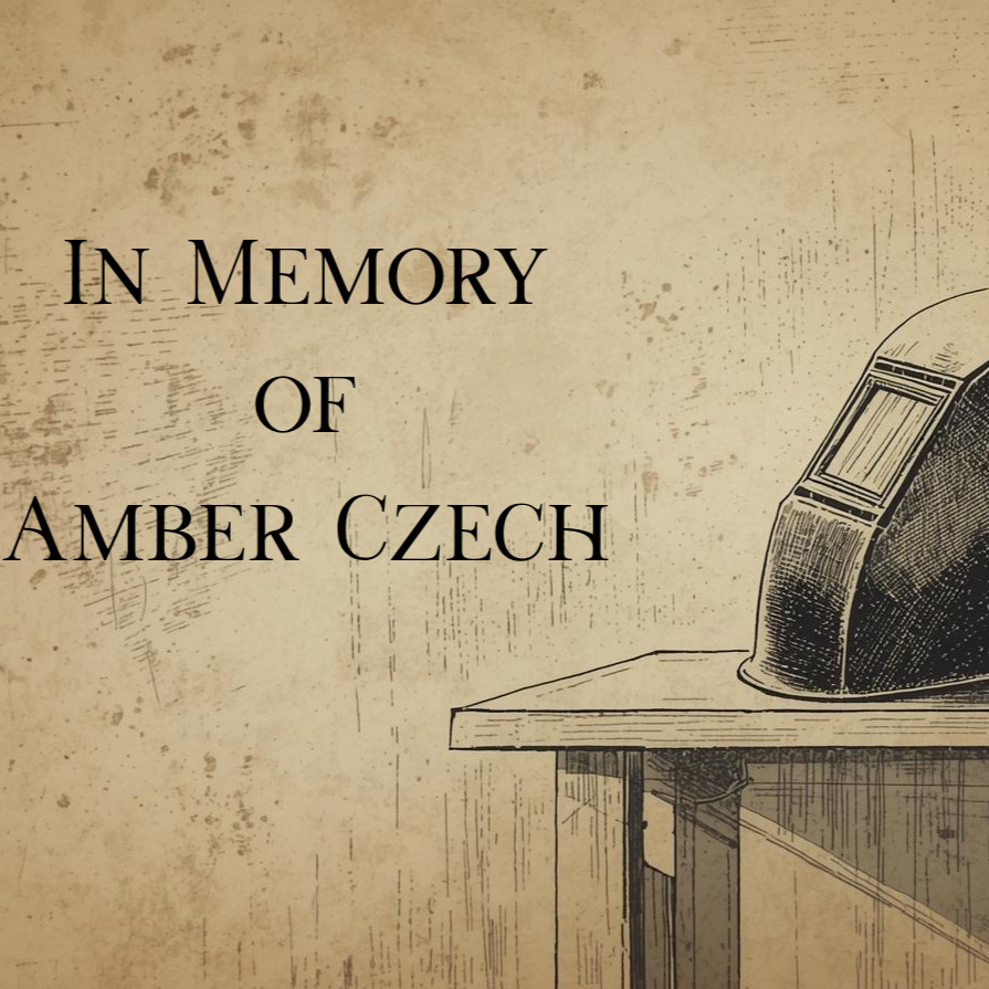 A vintage illustration with a beige background and a black and white drawing of a typewriter on a wooden desk. The text 'In Memory of Amber Czech' is displayed in large black font.