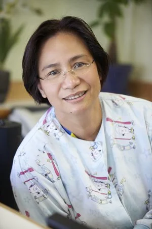 Dental hygienist with dental-themed scrubs at Dr. Kao Pediatric Dentistry in Daly City, CA
