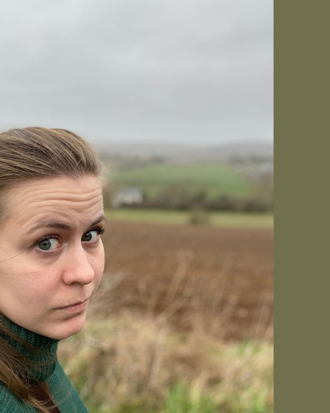 Close-up of woman with light brown hair and blue eyes in outdoor rural setting on overcast day