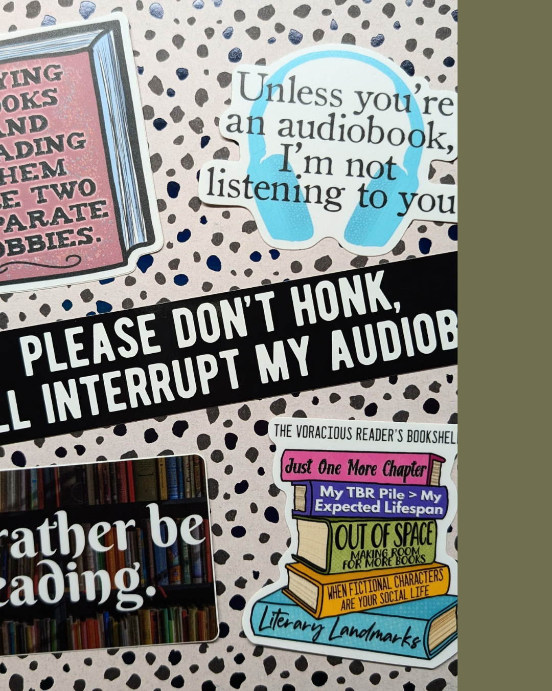 Collection of stickers on a polka dot background, including a sticker with a book shelf, a quote about audiobooks, and a sign asking not to interrupt an audiobook.