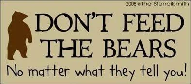A sign with a bear silhouette and the message 'DON'T FEED THE BEARS. No matter what they tell you!'