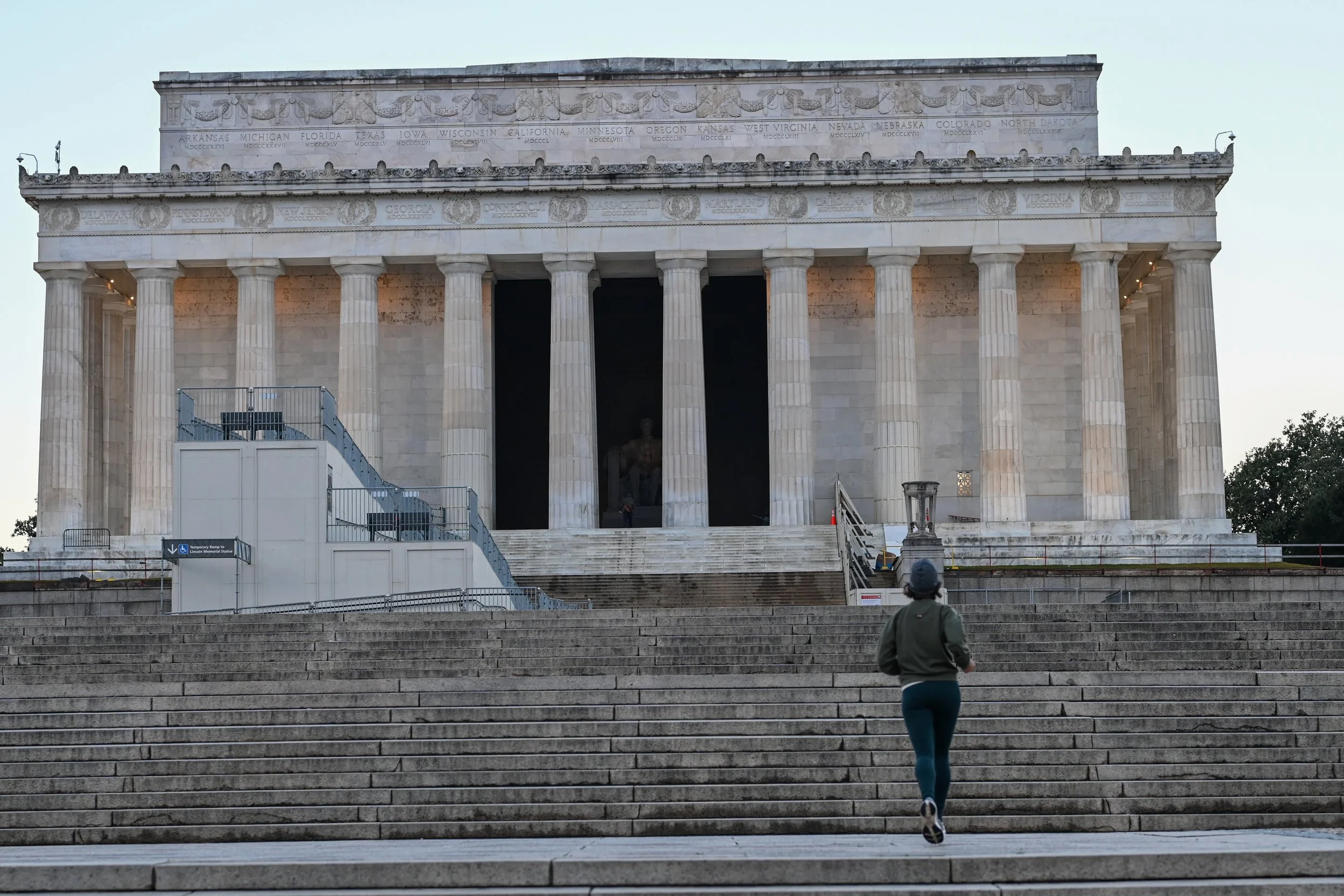 A person running up the steps towards the Lincoln Memorial in Washington, D.C.
