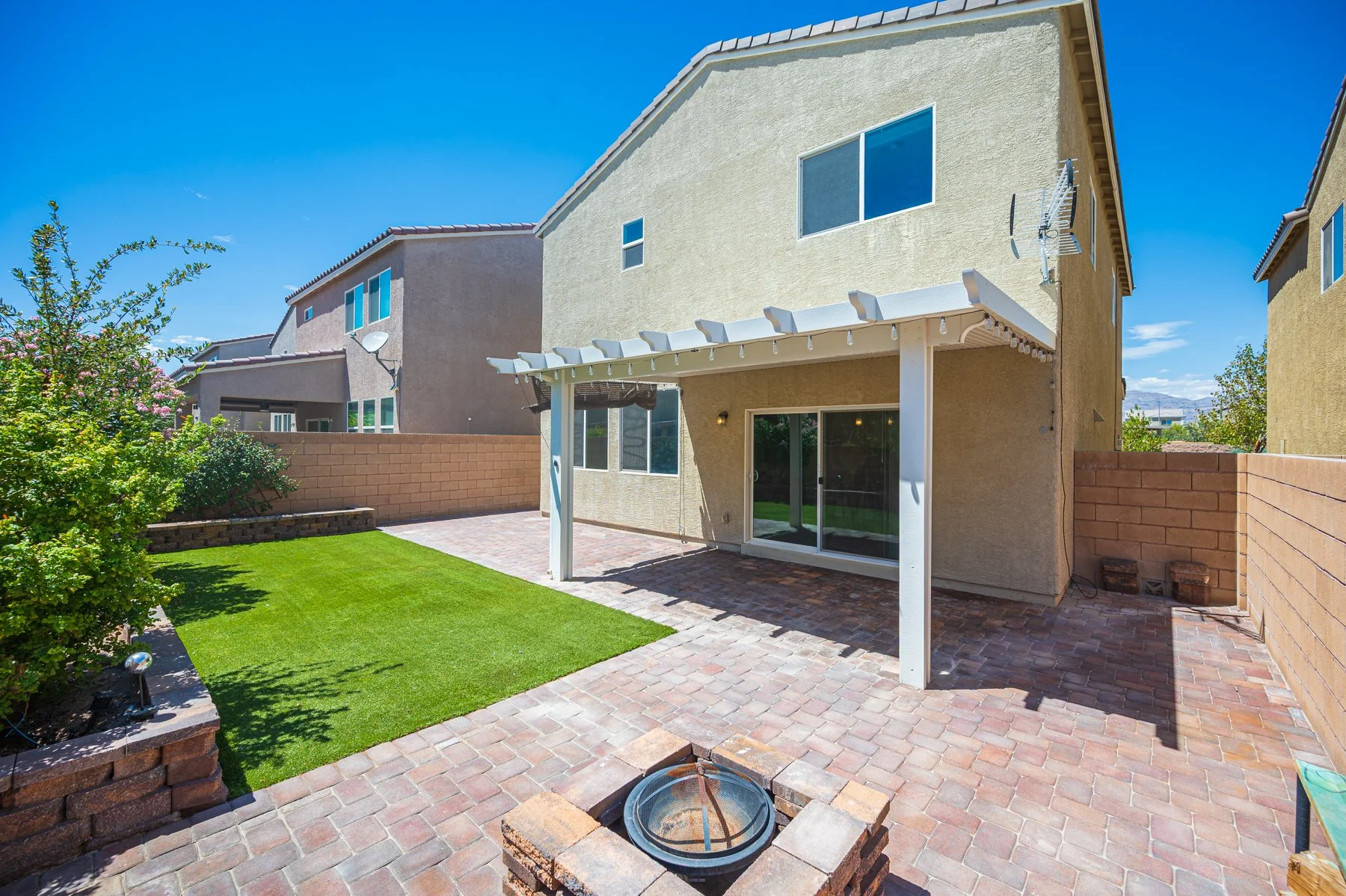Covered patio and paver backyard at 107 Broken Wagon Ave