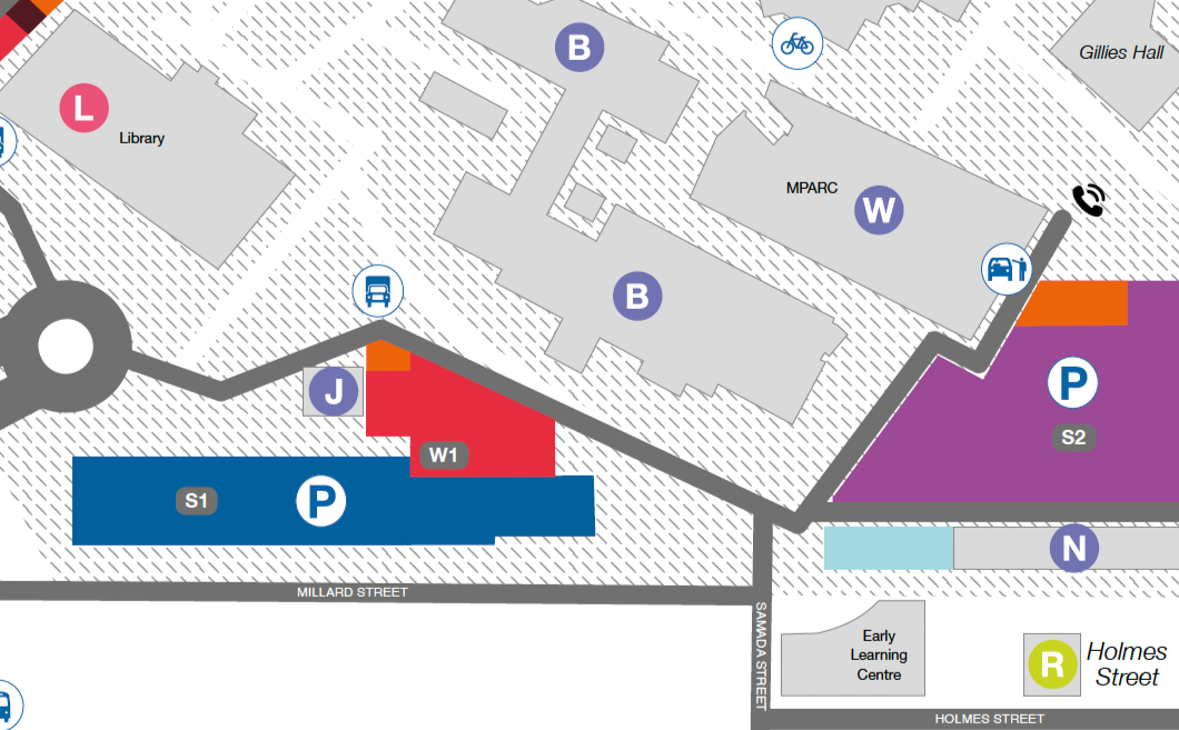A city campus map showing buildings, parking areas, bus stops, bicycle racks, and streets including Millard Street and Holmes Street.