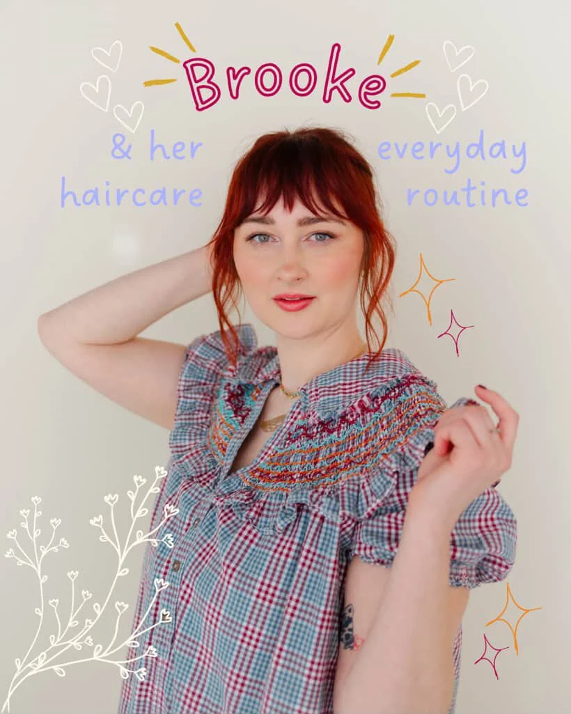 A woman with red hair posing with her hand behind her head wearing a plaid shirt against a plain background. Hand-drawn text and illustrations surround her, reading 'Brooke & her everyday haircare routine,' with decorative hearts, stars, and branches.