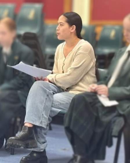Woman giving a speech about leadership to year 8 students who sit around her in a  big circle.