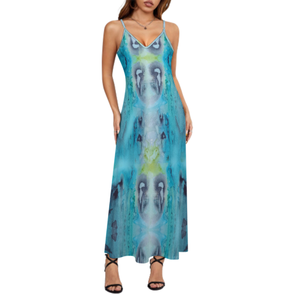 A woman wearing a long, sleeveless, blue hand painted underwater design dress. The dress features a symmetrical pattern, a reflection of underwater movements with blue, black, and green colors.