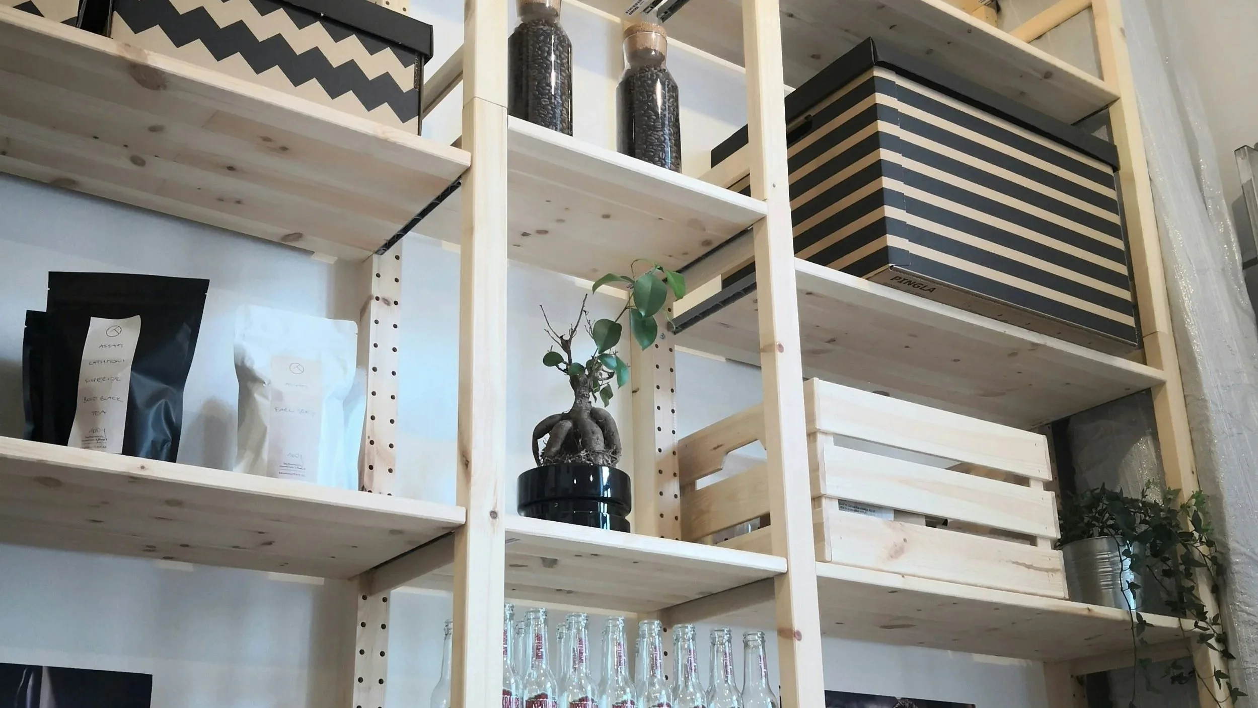 Organized wooden shelf with black and tan accents organized