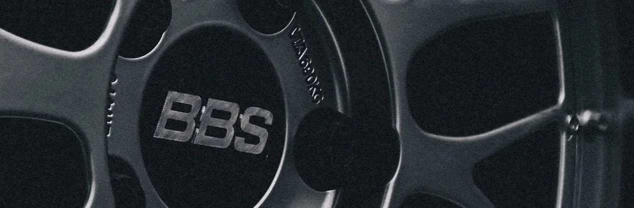 Close-up of a car stereo system featuring a JBL speaker with a BBS logo on the center cap.