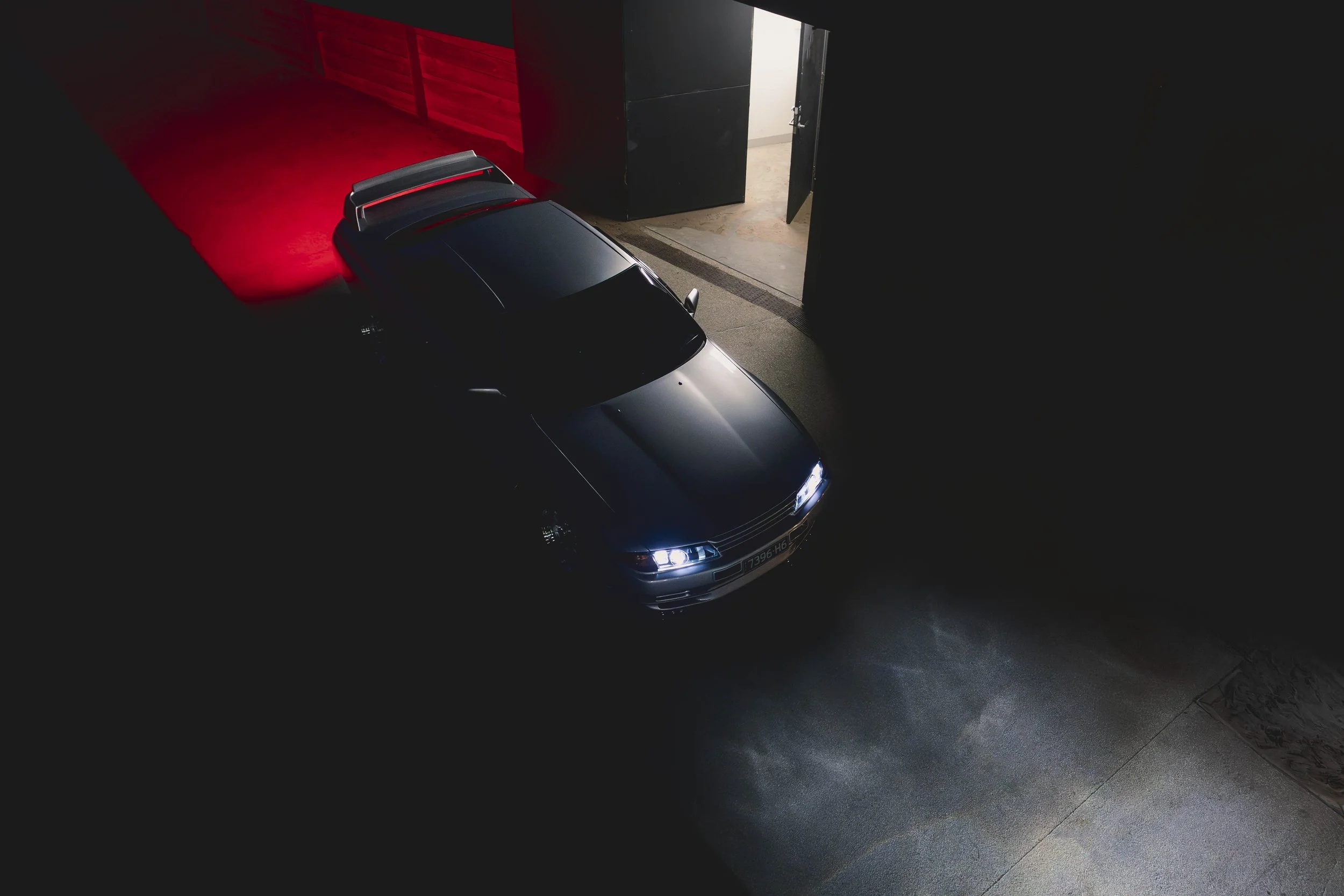 A Nissan Skyline R32 GTR with its headlights on