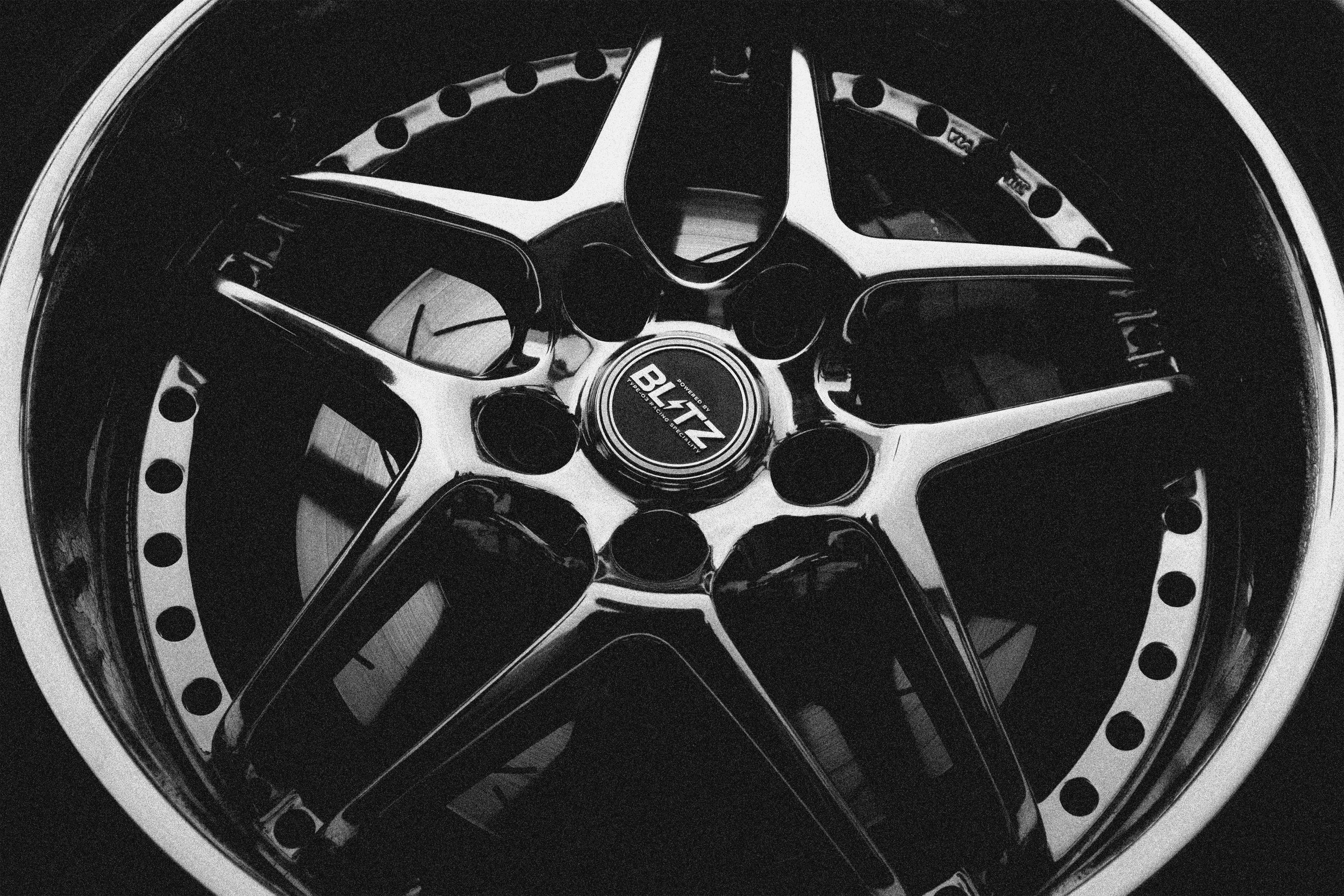 Close-up of a black and silver car wheel rim with a central logo that reads 'Blizz'.