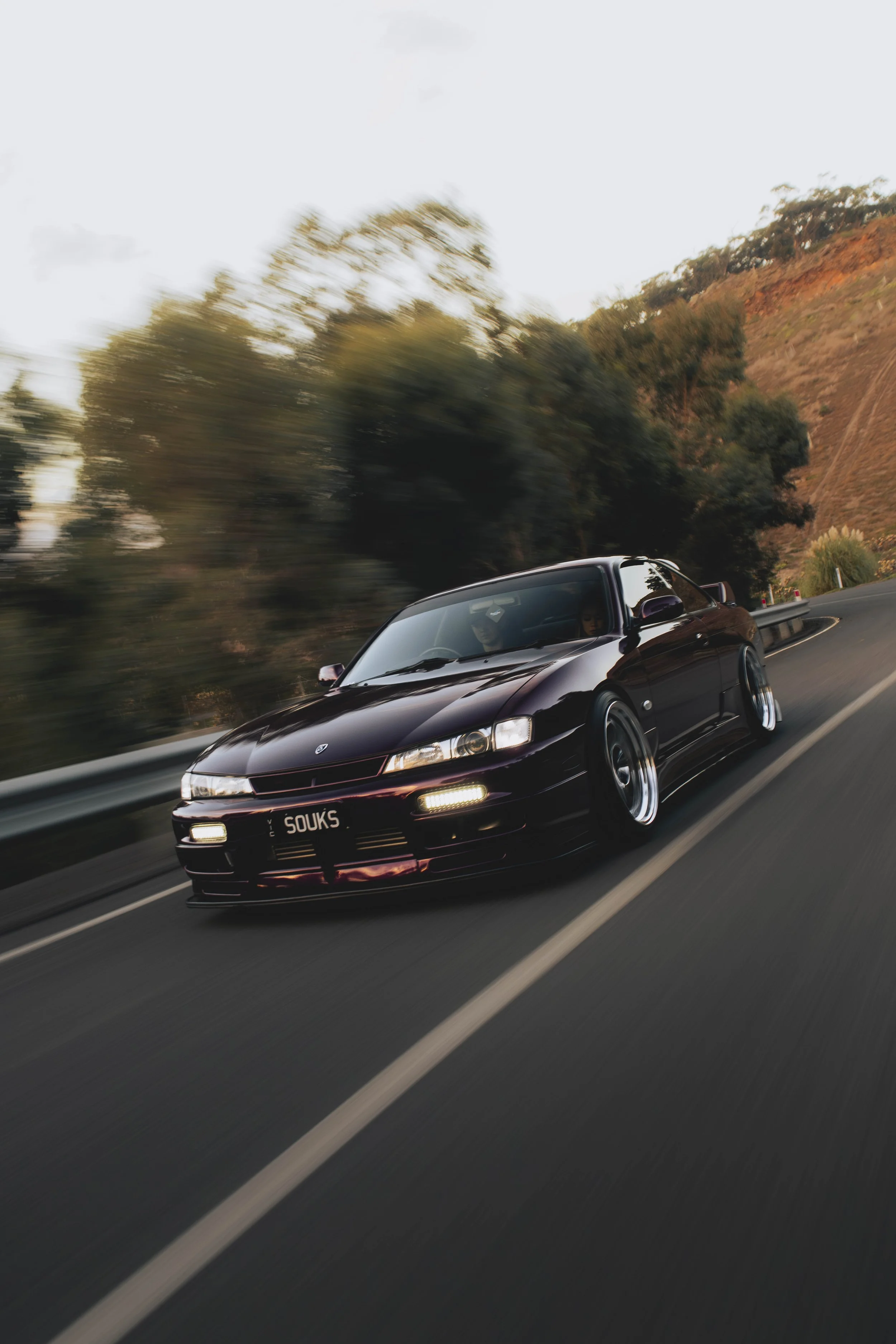 A modified Purple Nissan Silvia s14 200sx driving