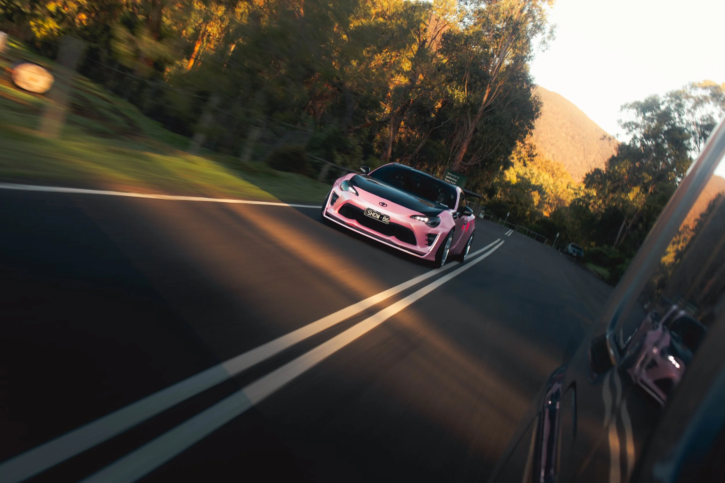 A Pink 86 driving in the forest