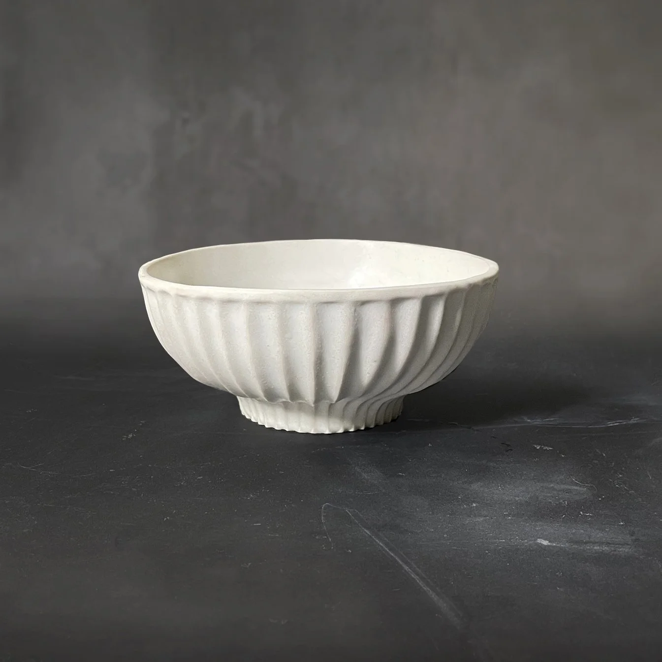 Handmade and carved raku bowl with white dolomite glaze