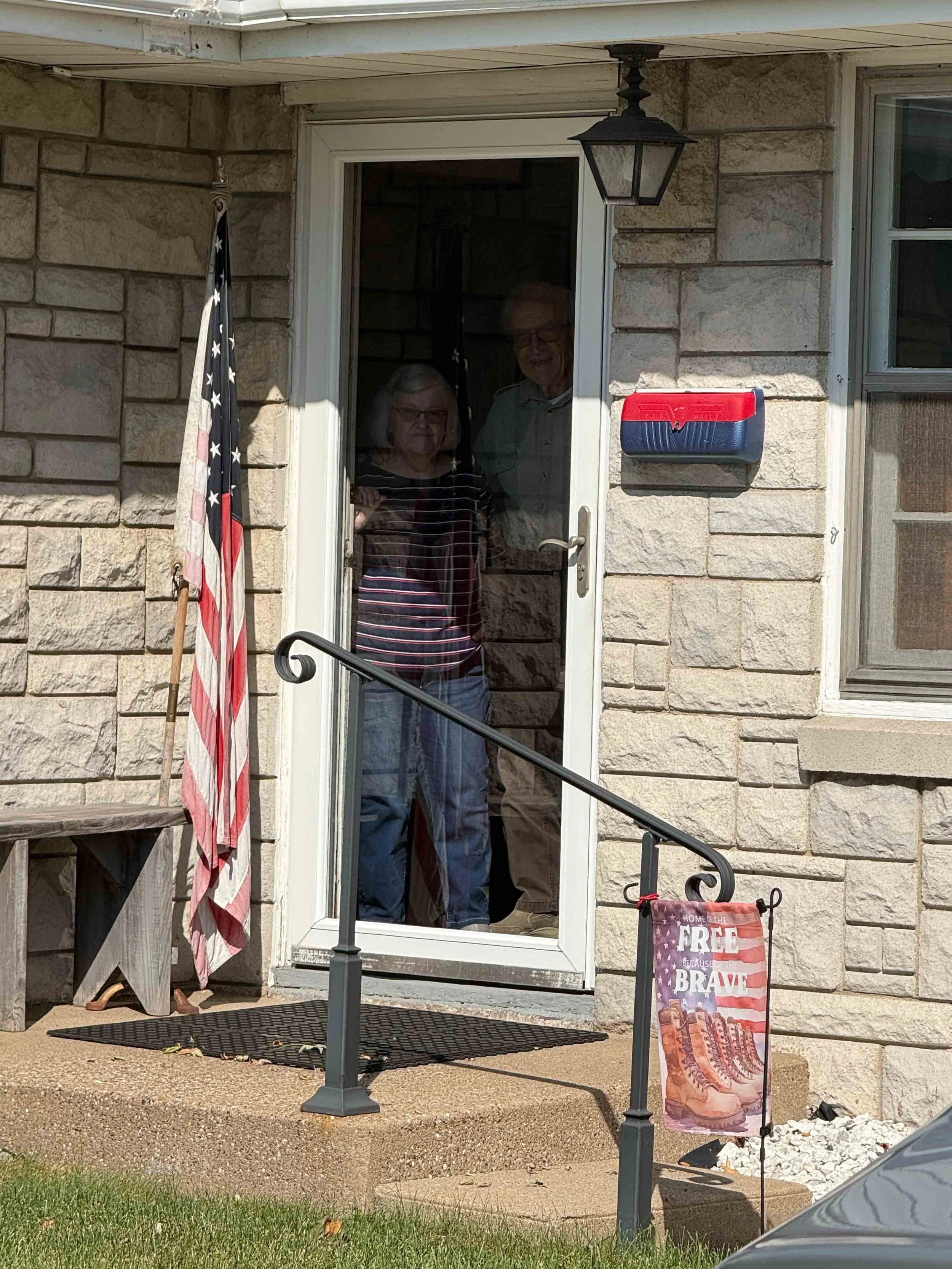 My aunt and uncle standing at the door while saying goodbye