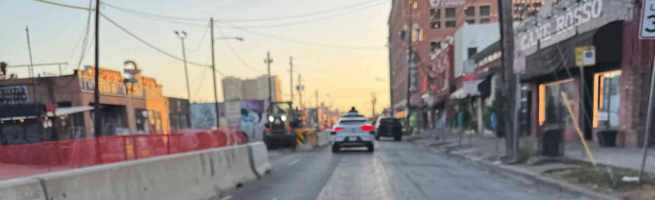 A Waymo drives down a street in Deep Ellum, Texas