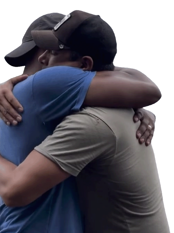 Two people hugging each other tightly in a warm embrace.