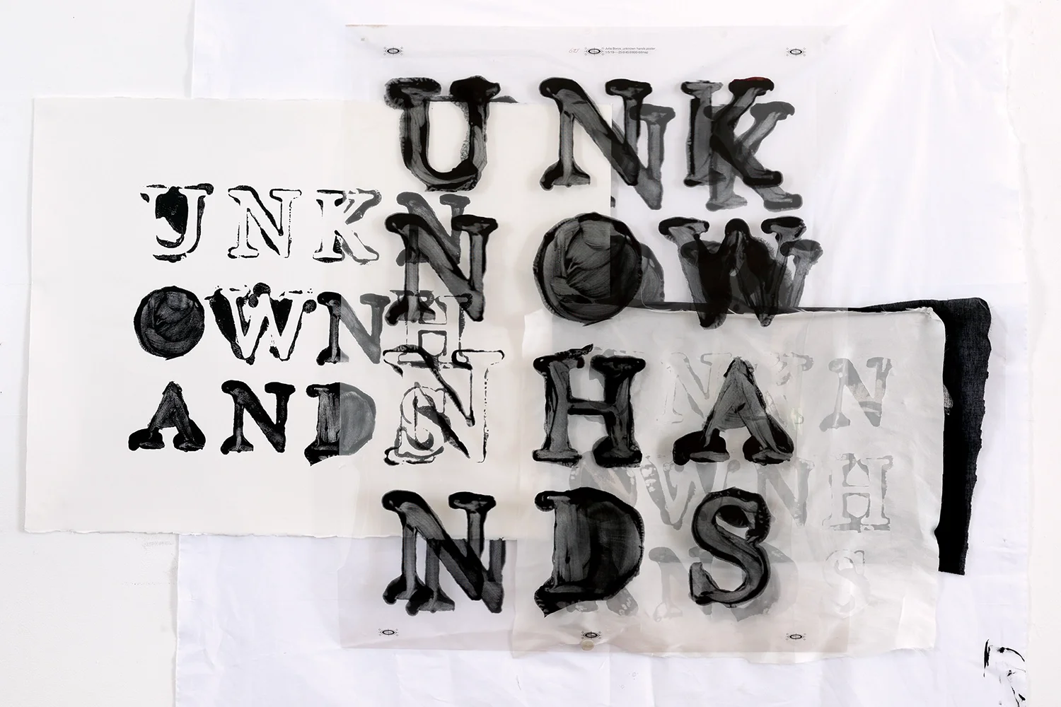 A print stencil and materials with the text 'Unknown Hands'