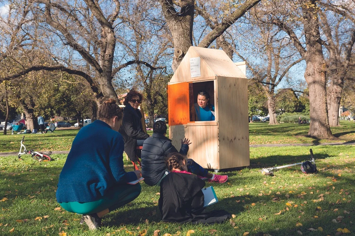 Artist talking to the public in a park on a sunny day