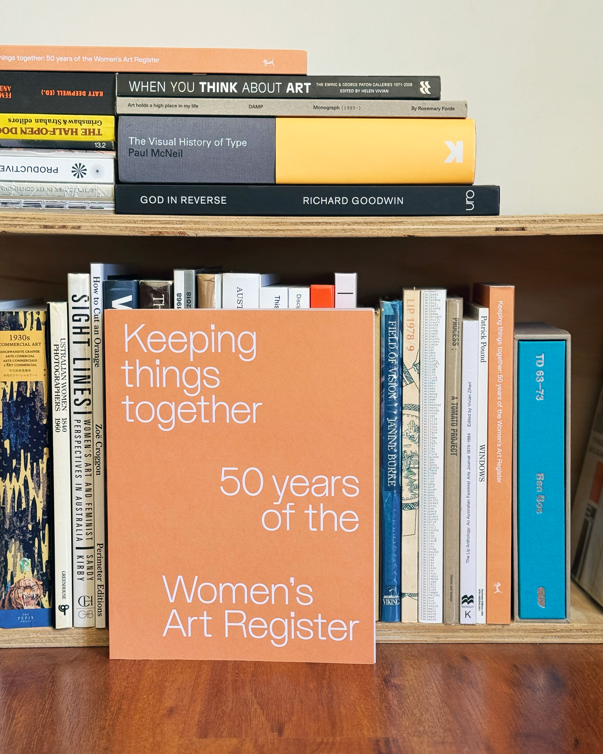 An orange cover book with the title in white text reading Keeping things together: 50 years of the Women's Art Register