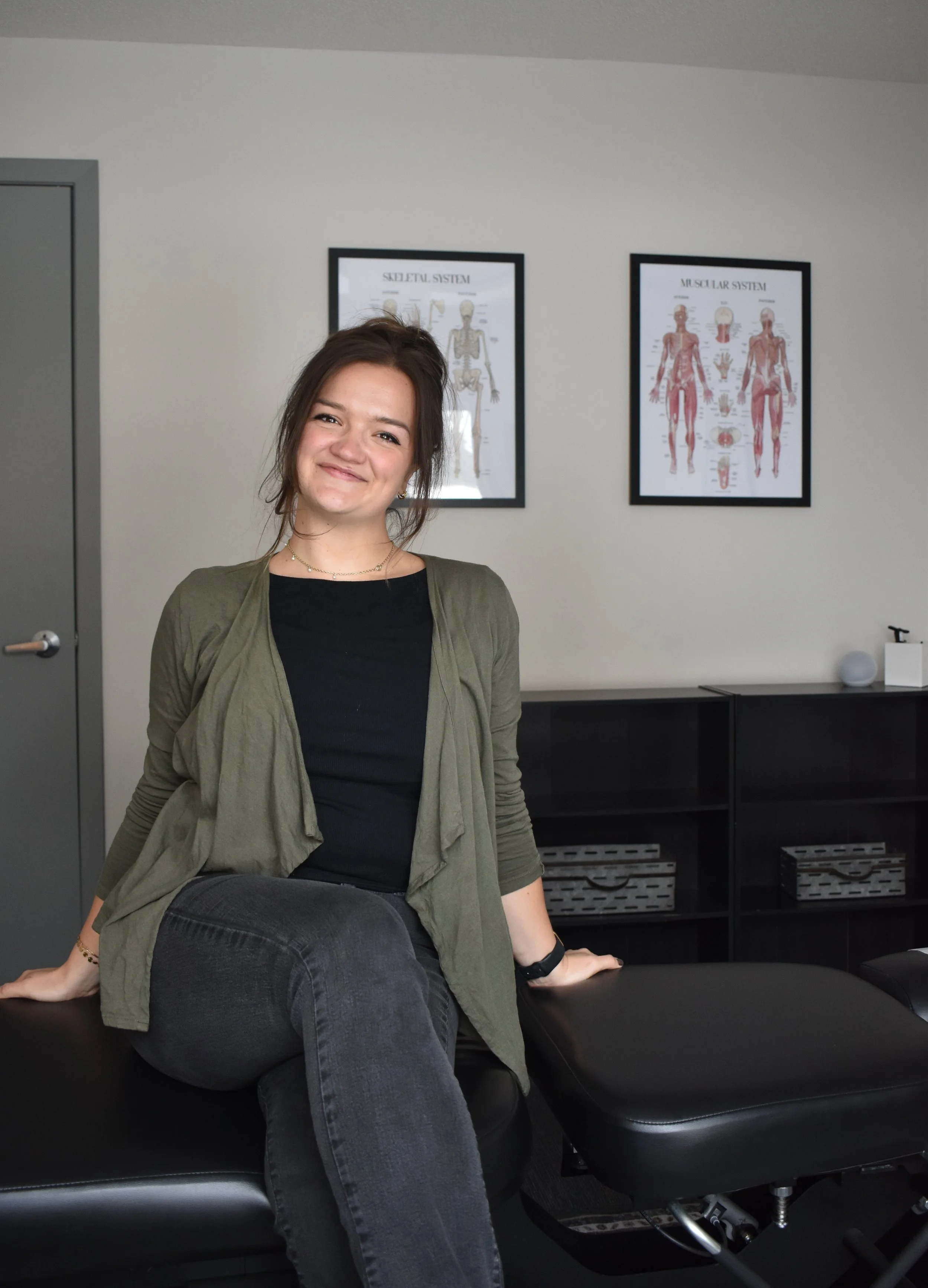 Photo of Kate Knaus, DC of True Movement Chiropractic sitting on adjustment chair