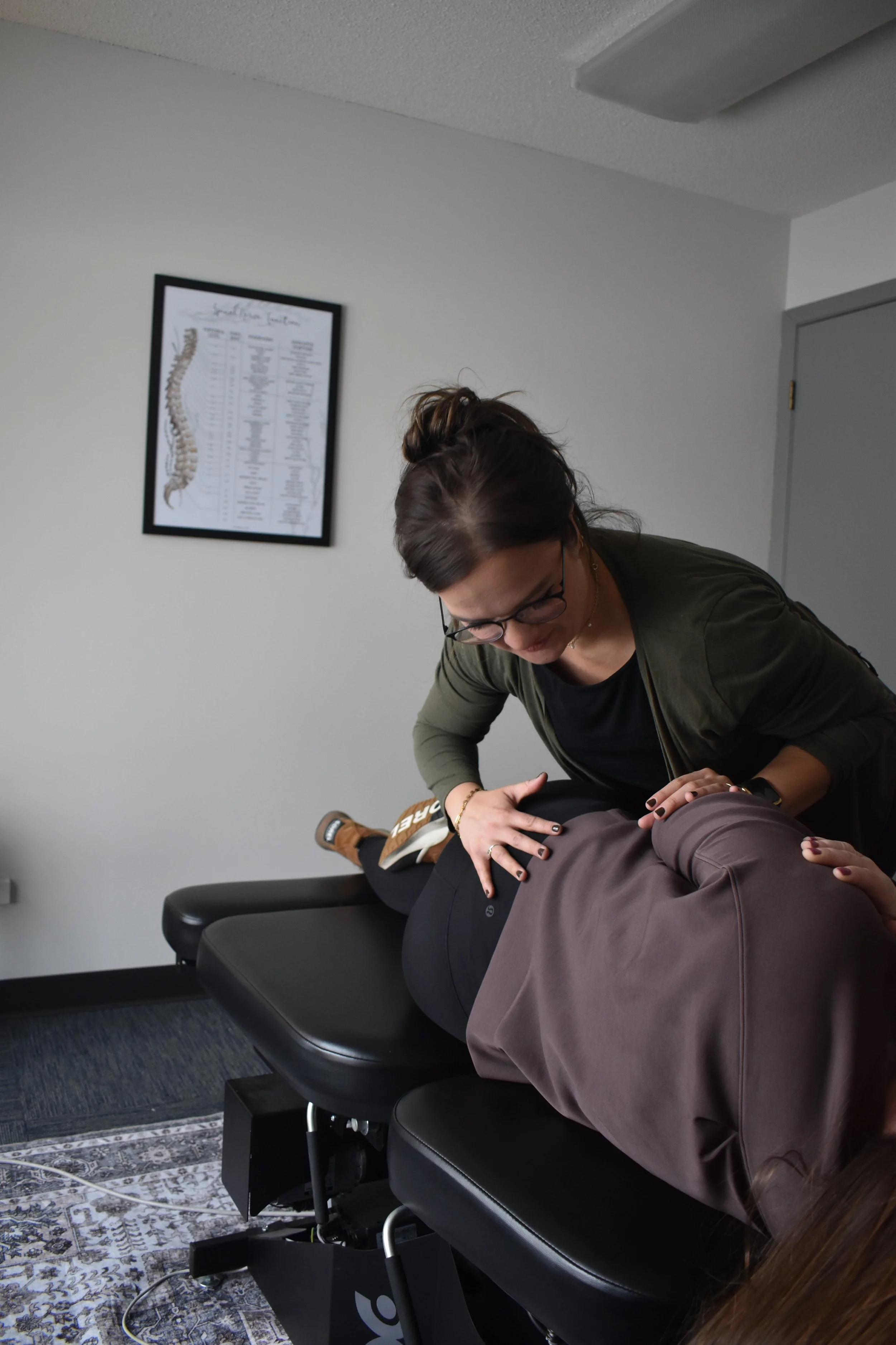 Kate Knaus performing a chiropractic adjustment on a patient