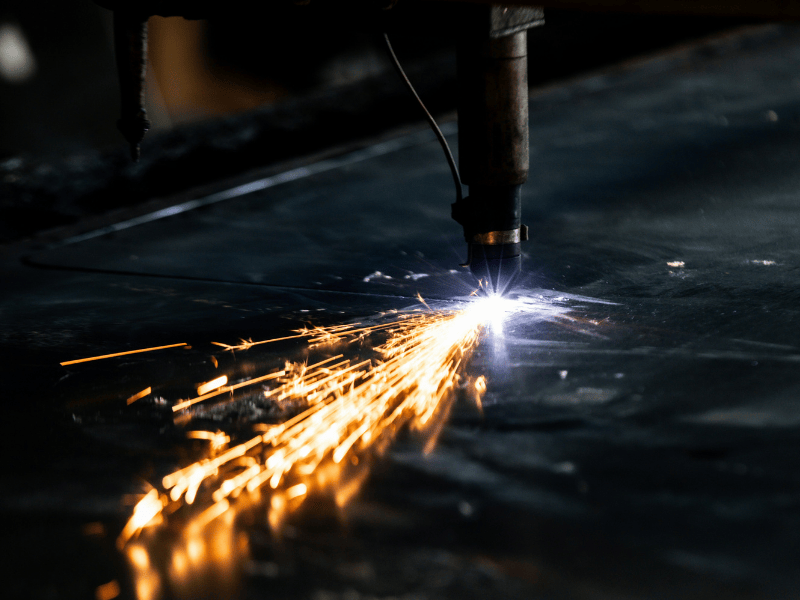 A welding torch producing sparks while welding metal.