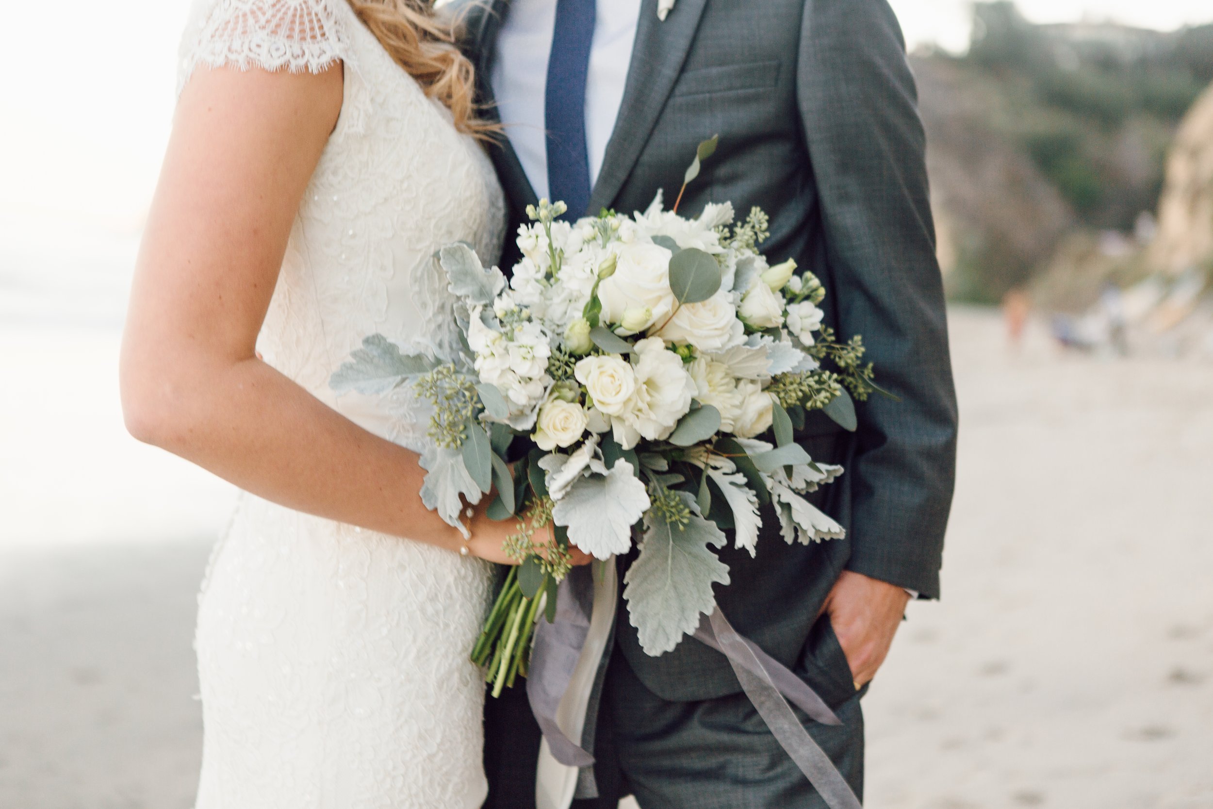 white bridal bouquet at the beach by Wild Spirit Floral