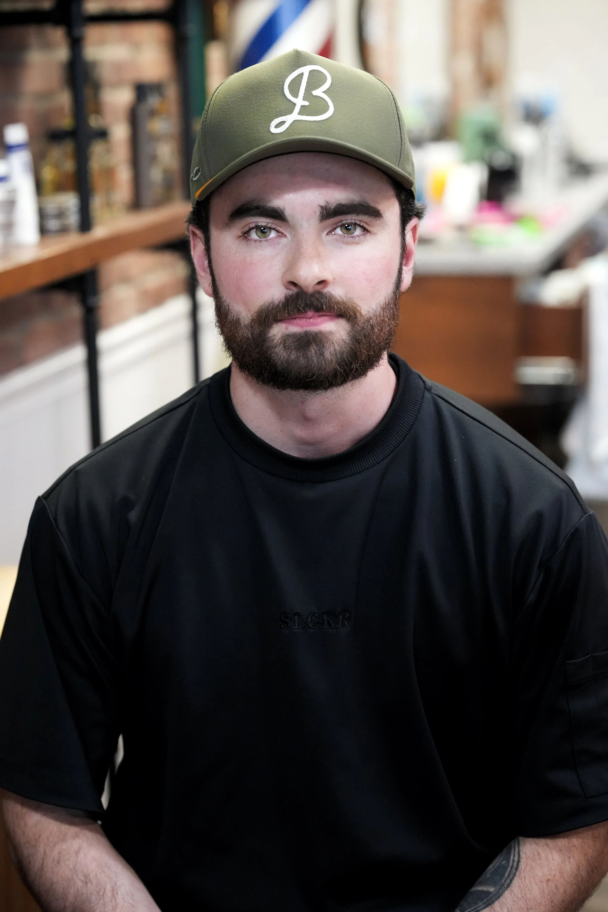 barber with beard and hat on