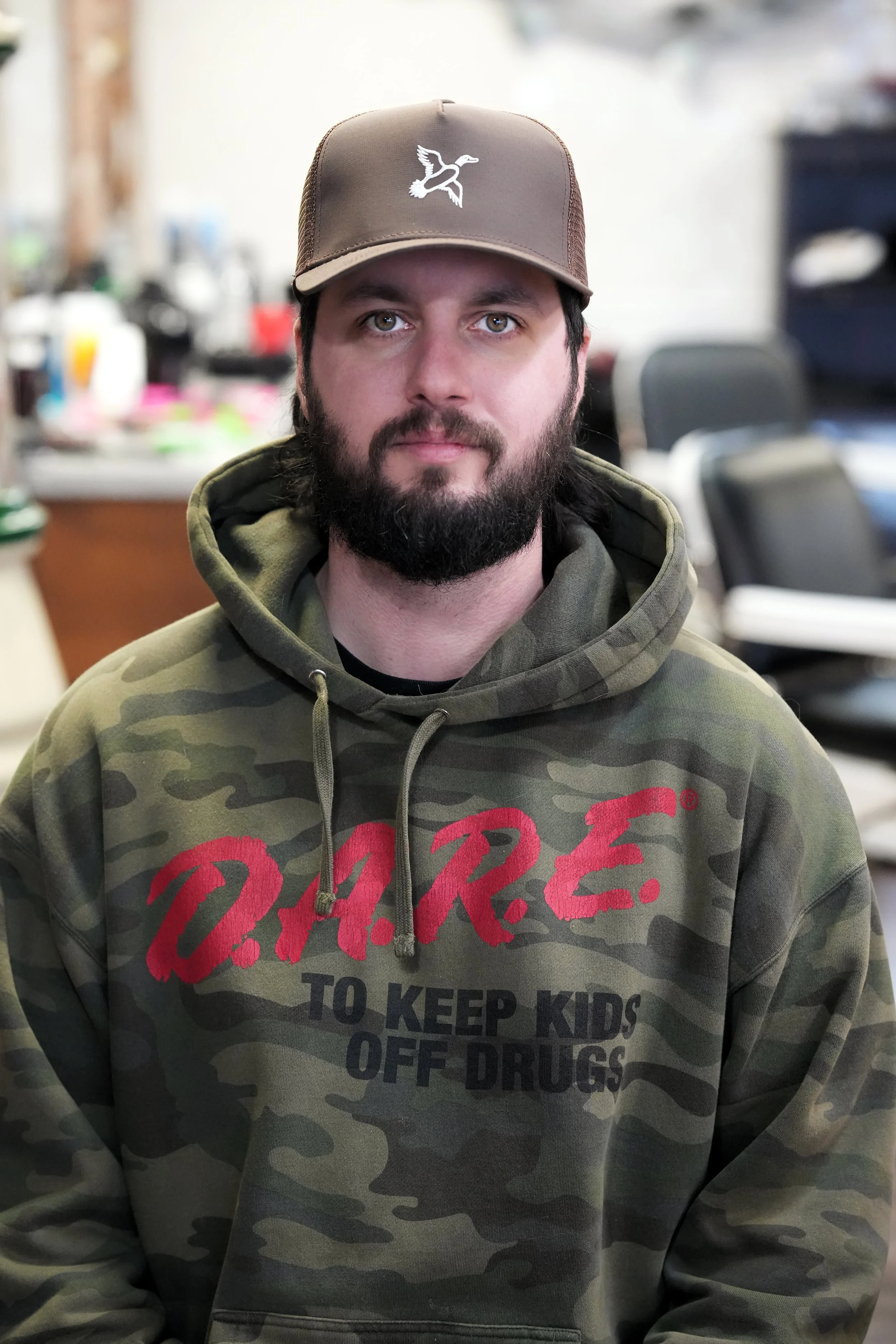 barber with beard and dare shirt