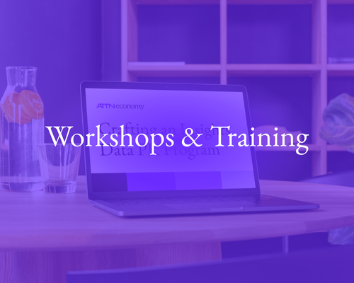 A laptop on a desk with the text 'Workshops & Training' overlayed, set in a purple-tinted office environment.