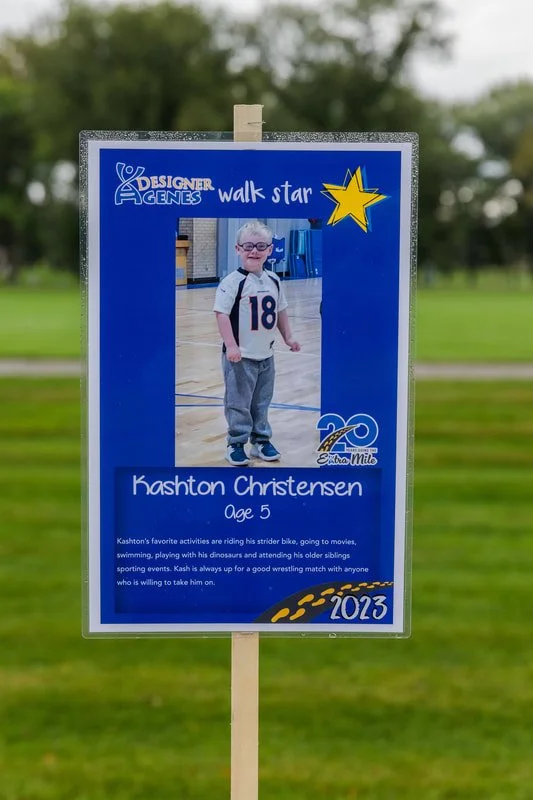 A poster for a walk star event featuring a young boy named Kashton Christensen, age 5. The poster includes a photo of Kashton in a gymnasium, wearing a sports jersey with the number 18, and the poster celebrates his achievements and interests, with a
