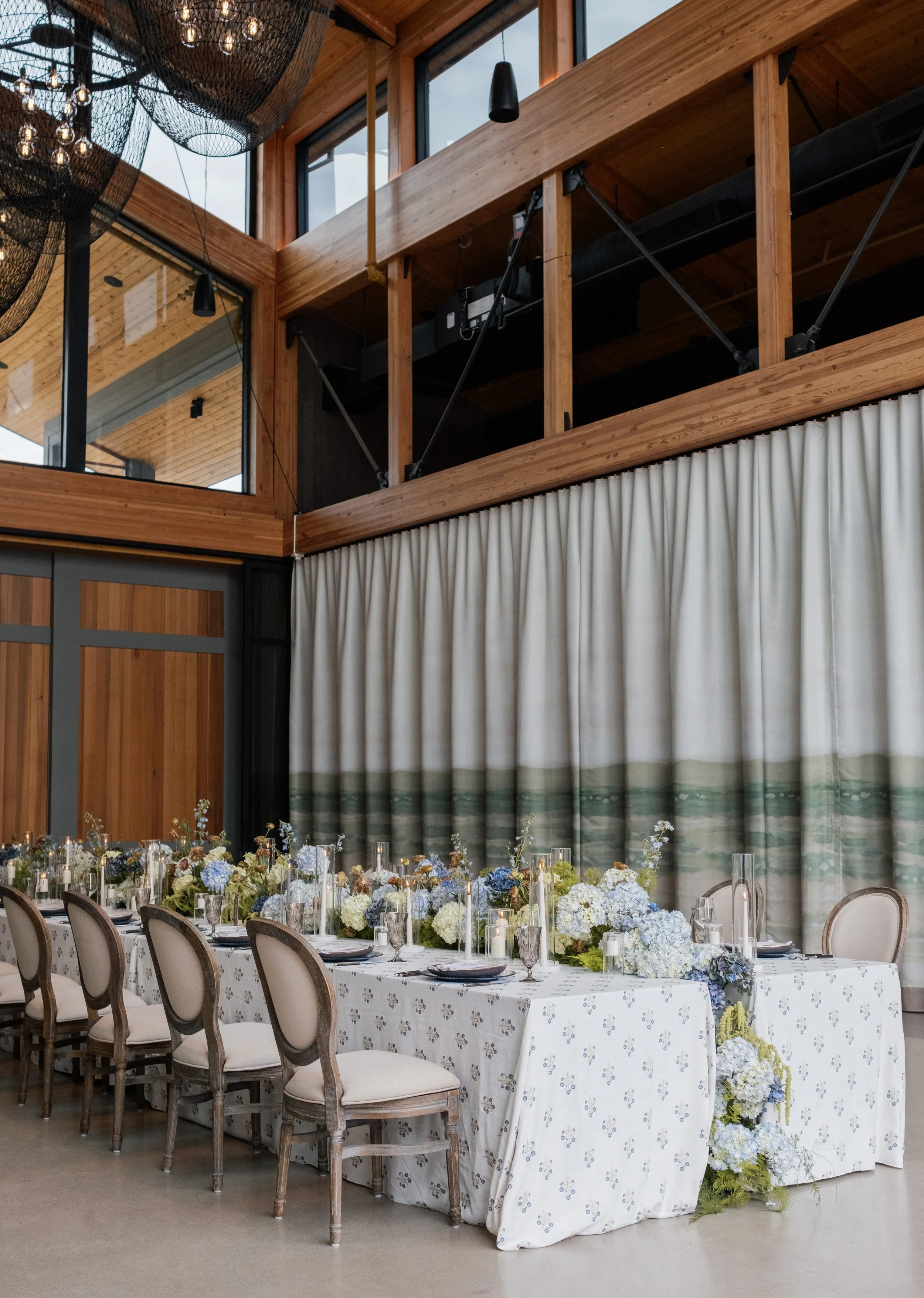 Elegant wedding reception at Appellation Healdsburg in Healdsburg, Sonoma County, California, featuring long banquet tables, modern architecture, and refined Wine Country décor.