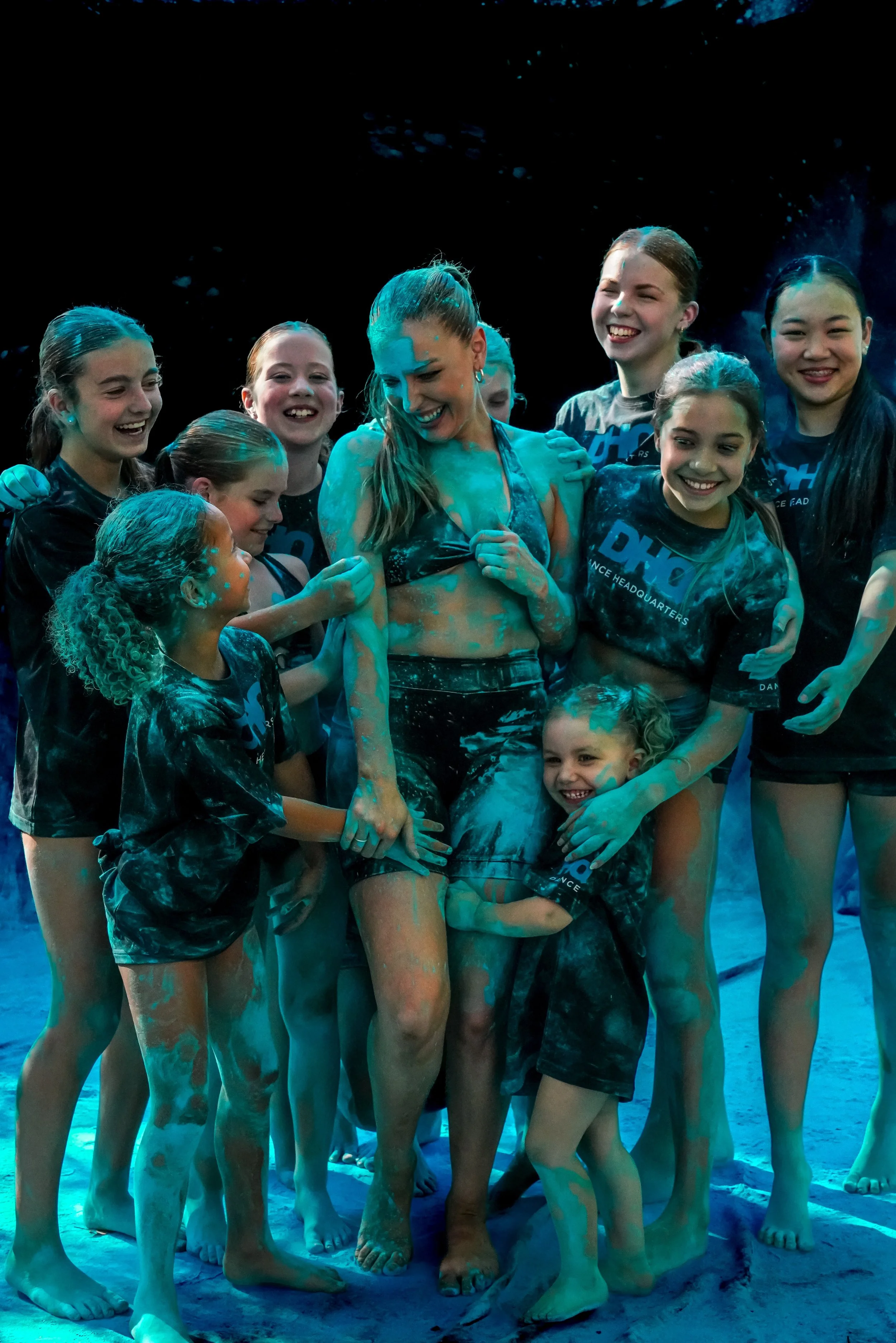 Group of Dance Headquarter student and owner, embracing at the rebrand photoshoot for the dance studio.