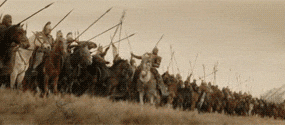 A scene of a large group of soldiers or warriors riding horses and charging forward across a field.