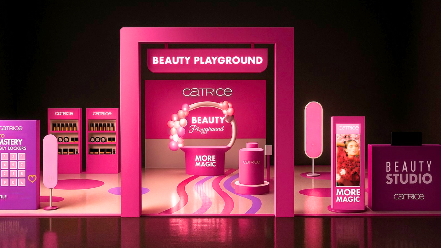 Pink-themed beauty shop display with shelves of products, digital screens, a circular sign with bubbles, and signs reading 'Beauty Playground' and 'Beauty Studio'.