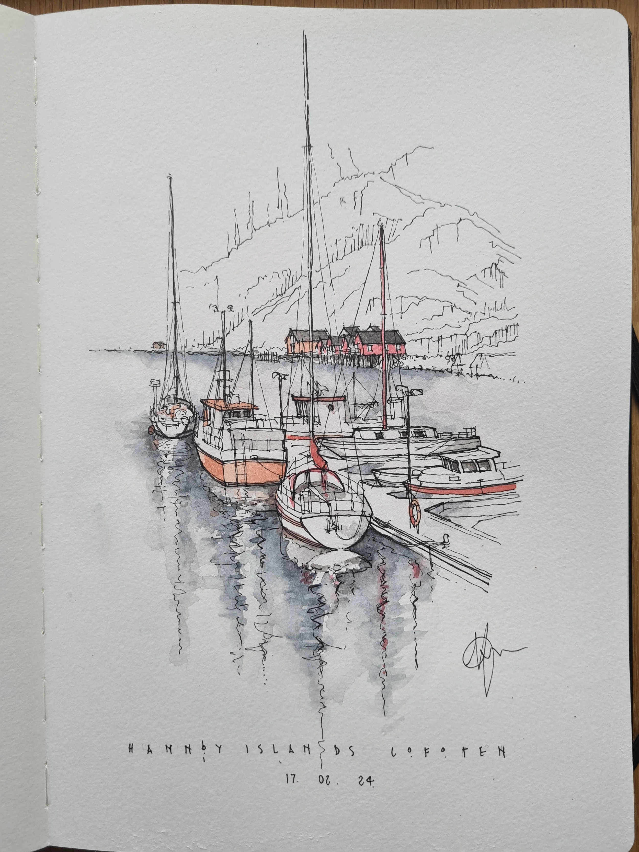 A watercolor sketch of boats docked in a harbor with mountains and buildings in the background, labeled 'Hamnby Islands Lofoten,' dated February 24, 2017.